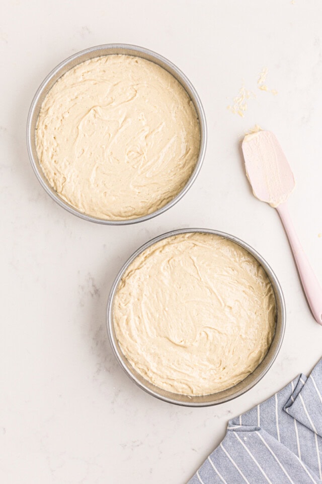 vanilla cake batter in two round cake pans before baking