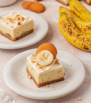 banana pudding cheesecake bar with layers of vanilla cookie crust, banana cheesecake, and whipped cream