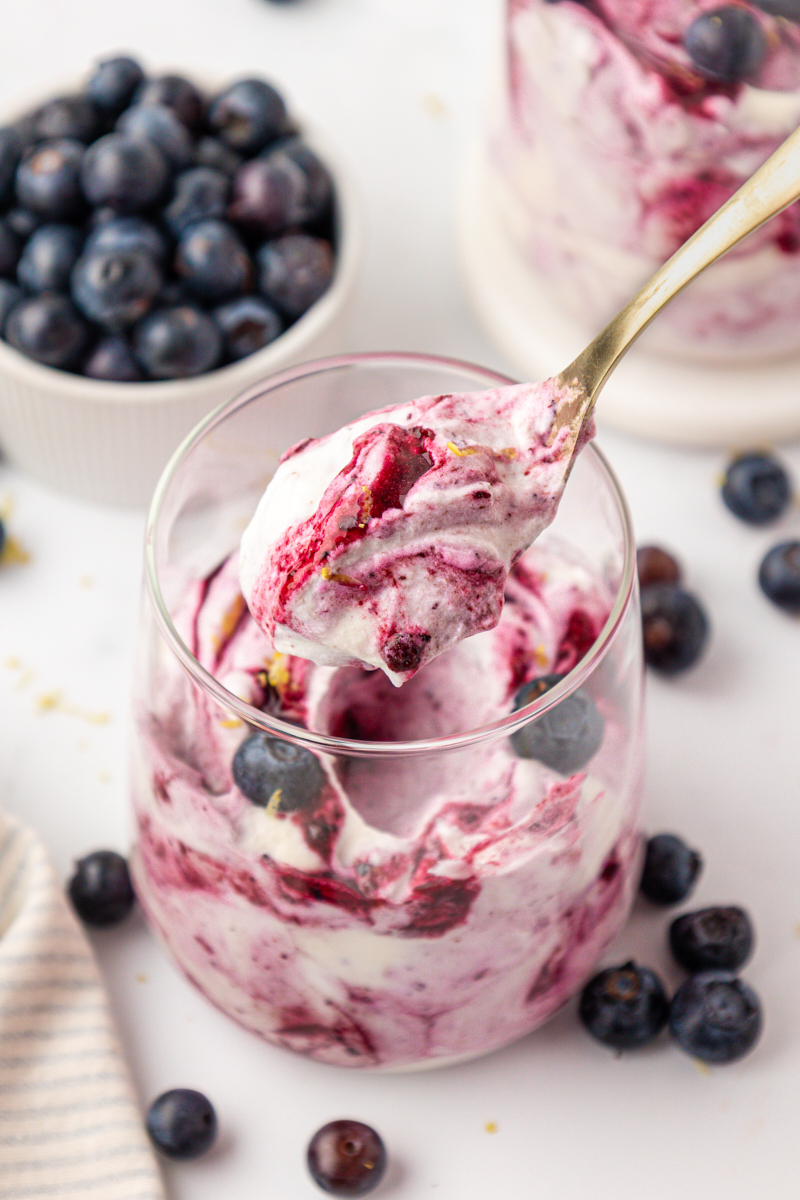 a spoonful of blueberry fool showing the swirl of blueberry purée in the whipped cream