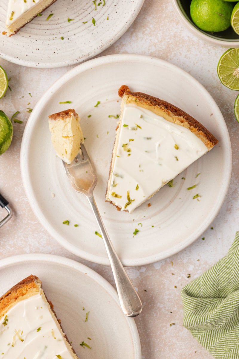 overhead view of a slice of Key lime cheesecake with a bite on a fork