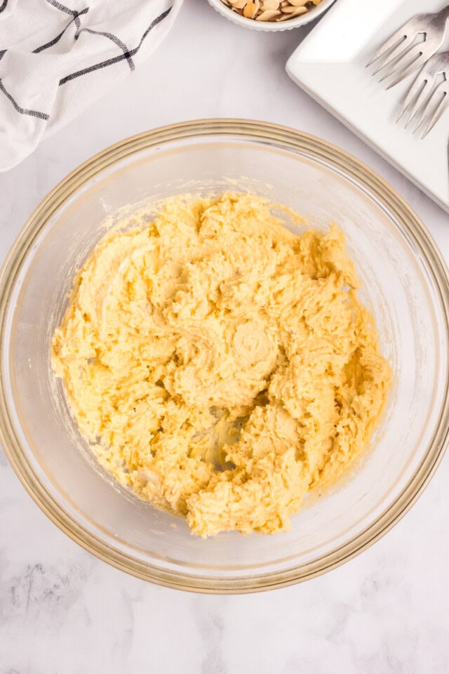 overhead view of almond cake batter in a mixing bowl