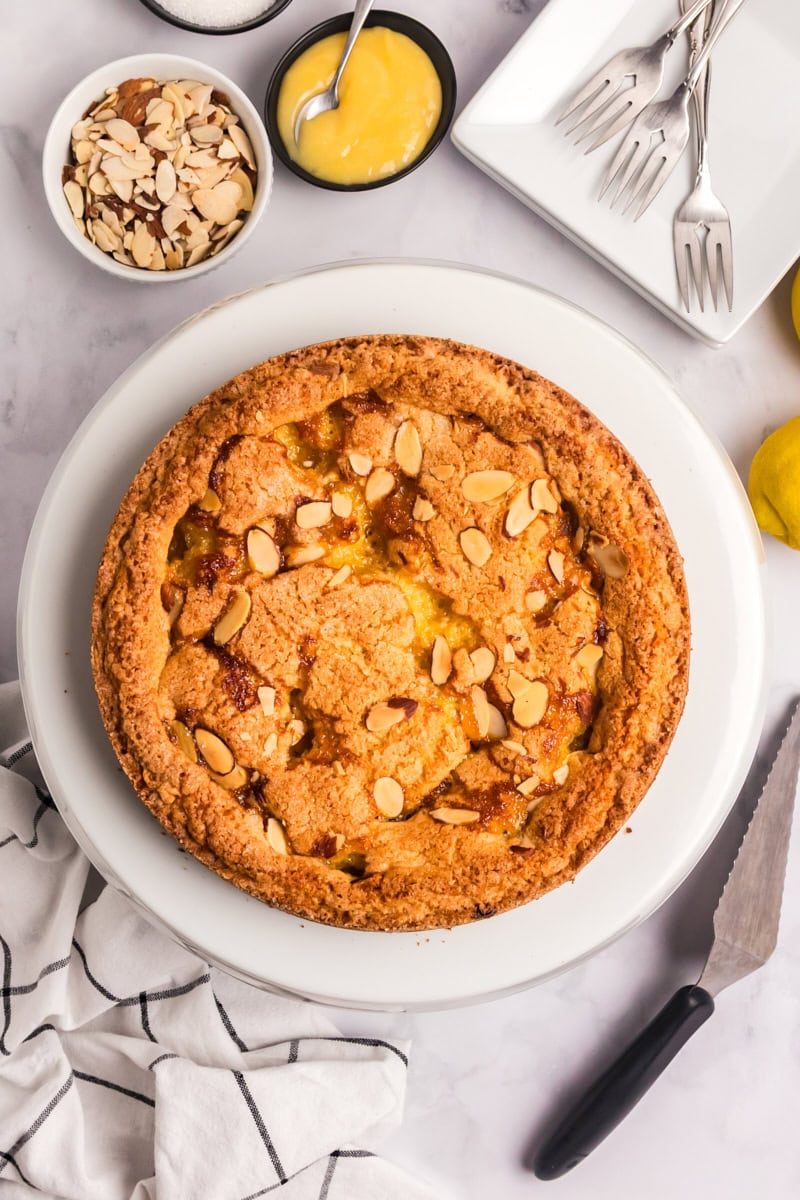 lemon almond cake on a white cake stand