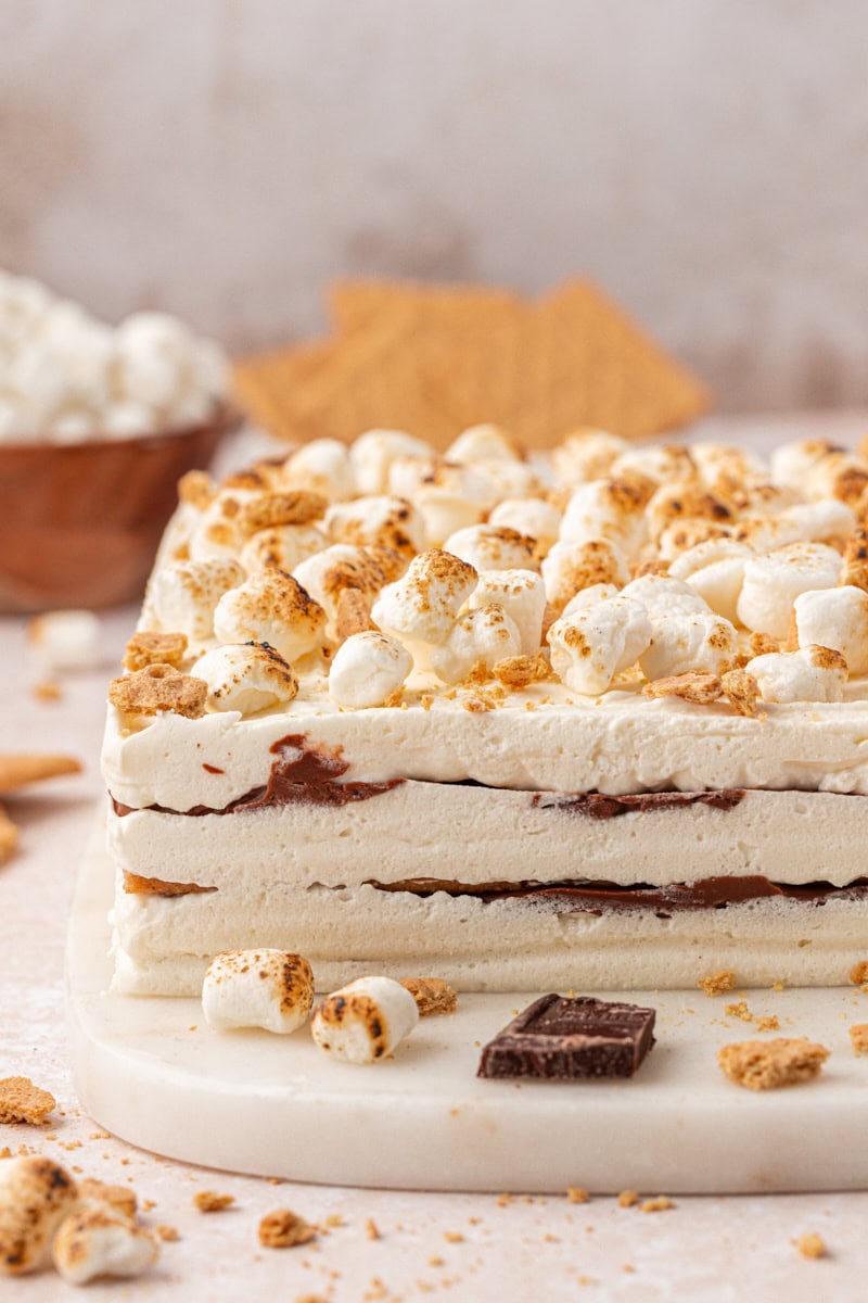 s'mores icebox cake garnished with toasted marshmallows and graham cracker crumbs
