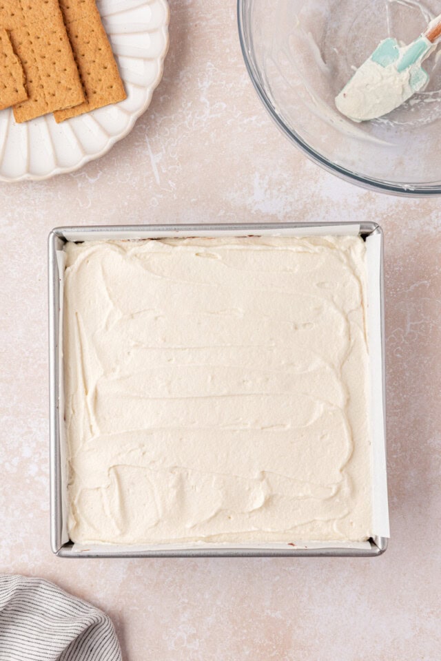 s'mores icebox cake assembled in a square pan ready to go into the refrigerator