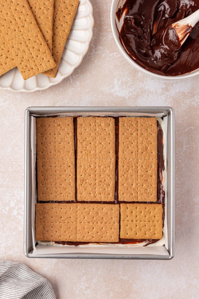 a layer of graham crackers on top of marshmallow filling and chocolate ganache