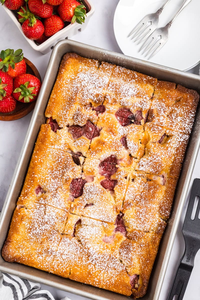 overhead view of freshly baked strawberry cheesecake cobbler in a 9x13 pan