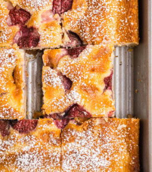 overhead view of strawberry cheesecake cobbler cut into squares