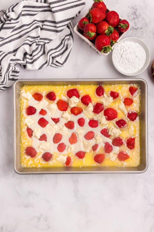 strawberry cheesecake cobbler in a 9x13 pan before going into the oven