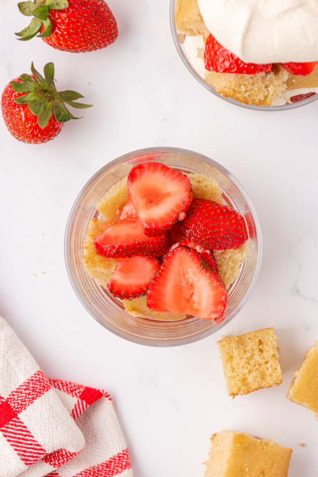 vanilla cake cubes topped with macerated strawberries in a jar