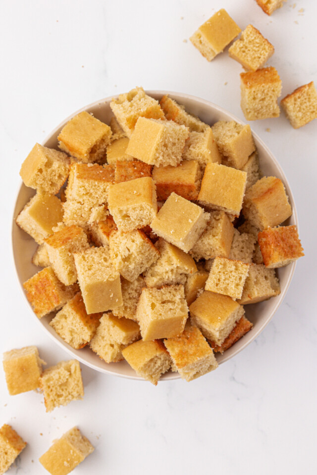 cubes of vanilla cake ready to layer into strawberry shortcake jars