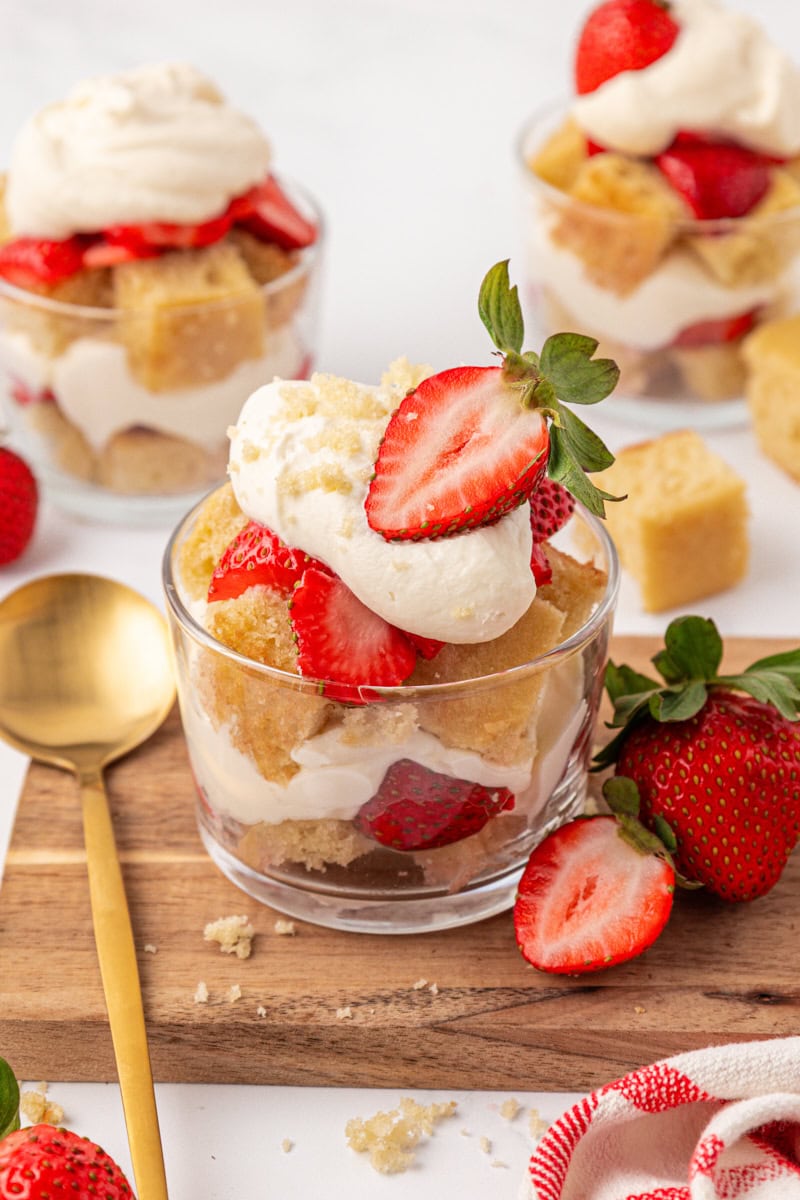 a strawberry shortcake jar with vanilla cake cubes, whipped cream, and macerated strawberries