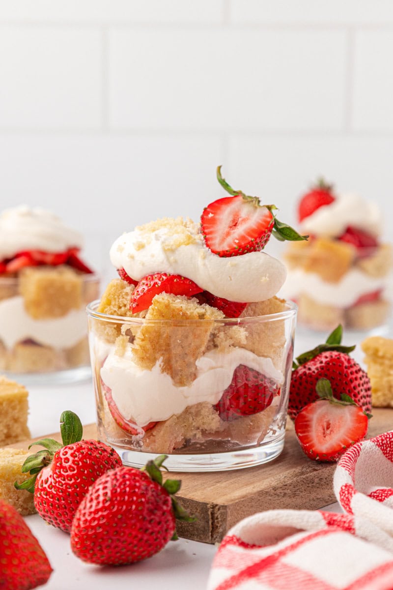 strawberry shortcake jars with layers of vanilla cake, stabilized whipped cream, and macerated strawberries
