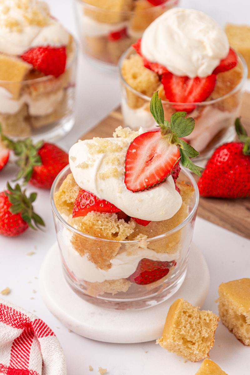 layers of vanilla cake pieces, whipped cream, and macerated strawberries to make strawberry shortcake jars
