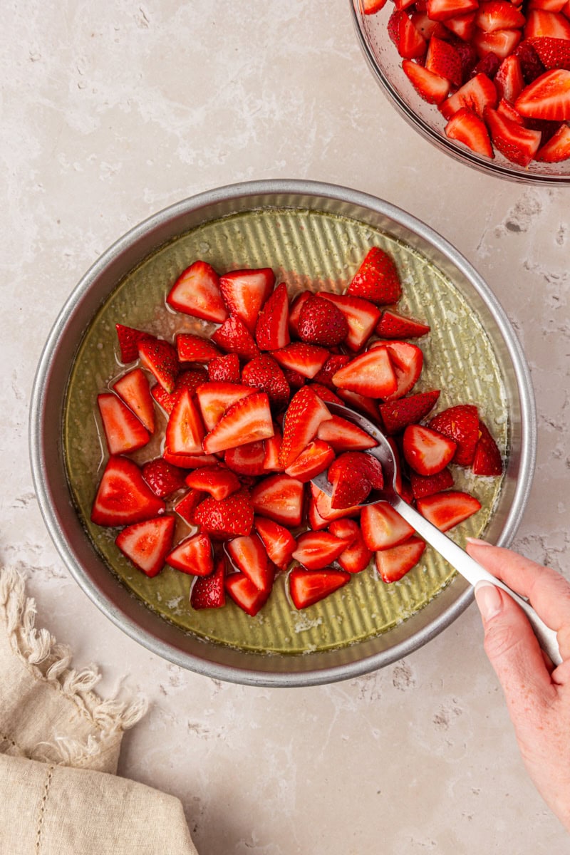 strawberries added to a pan with melted butter