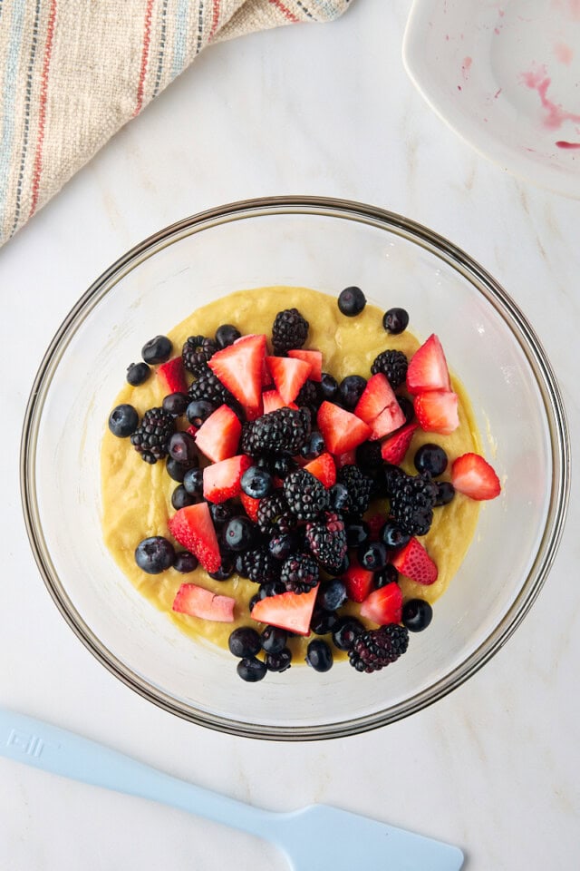 overhead view of fresh berries added to muffin batter