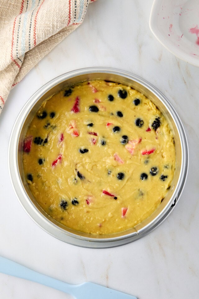 overhead view of berry muffin cake before baking