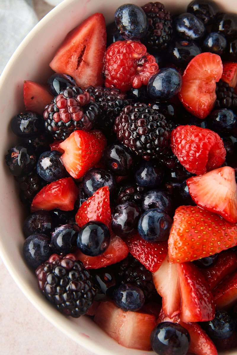 close up overhead view of macerated berries, including strawberries, blueberries, raspberries, and blackberries