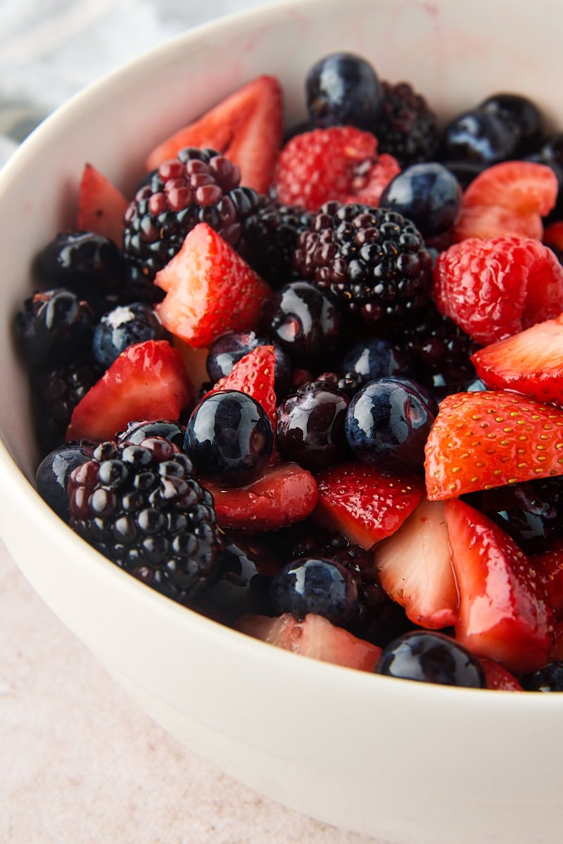 macerated mixed berries in a white bowl