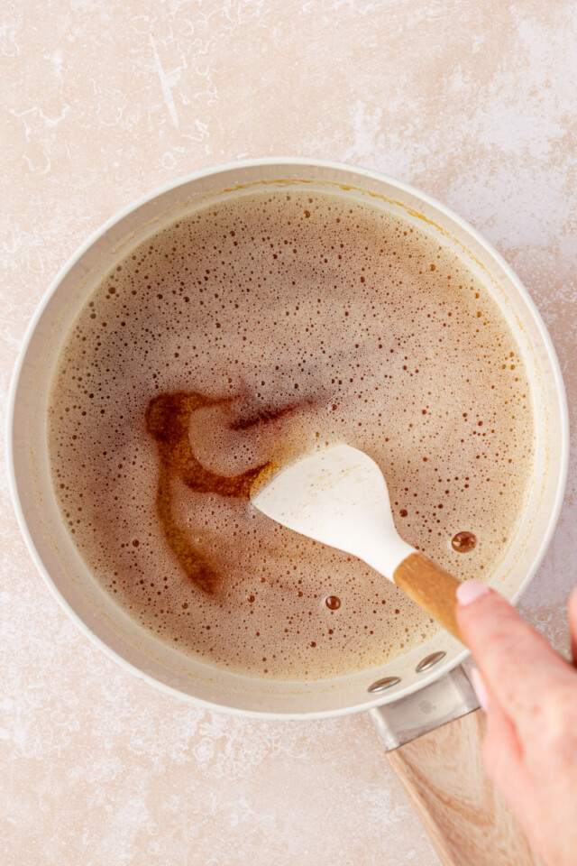 browned butter being stirred in a saucepan