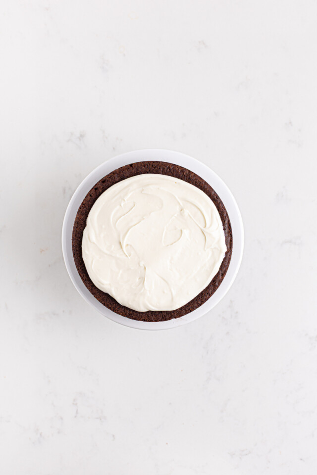 cream cheese filling spread on a chocolate cake layer