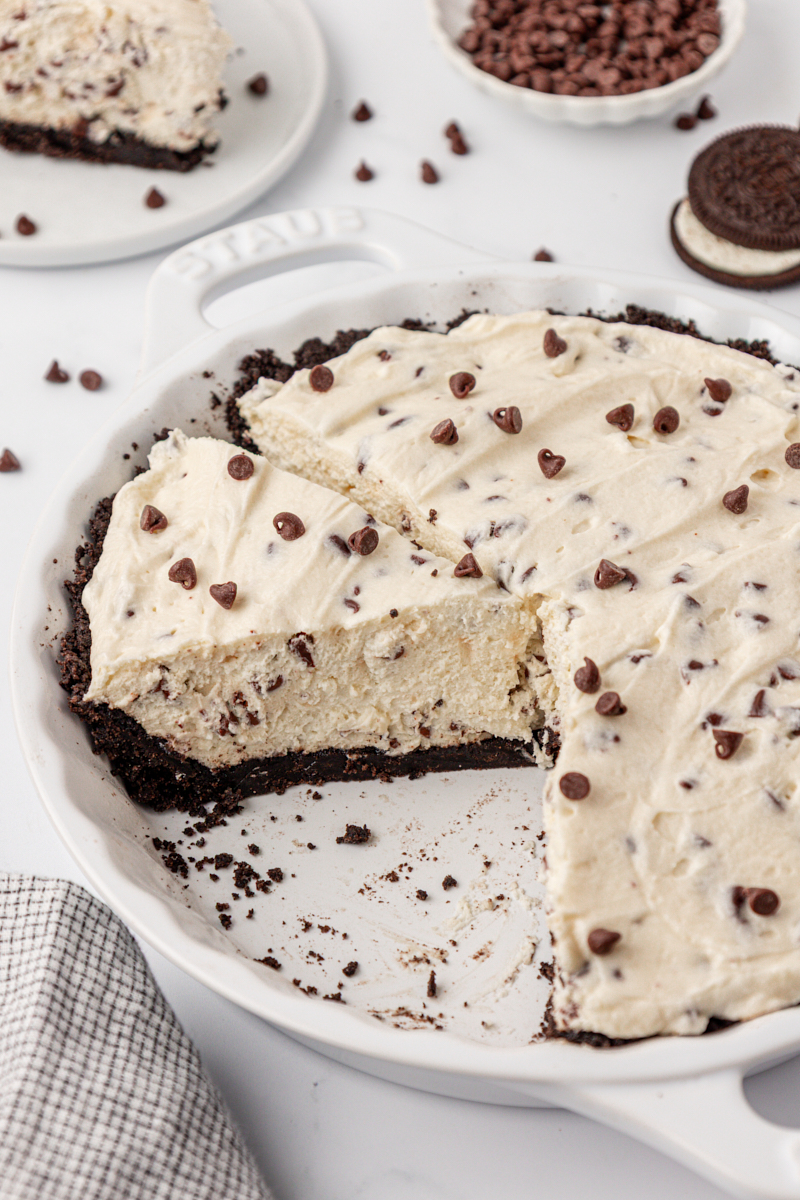 partially sliced chocolate chip icebox pie with Oreo crust