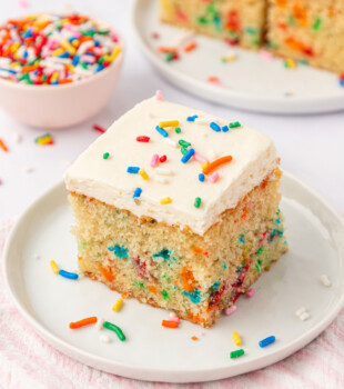 sprinkle-filled funfetti sheet cake topped with vanilla frosting and more sprinkles