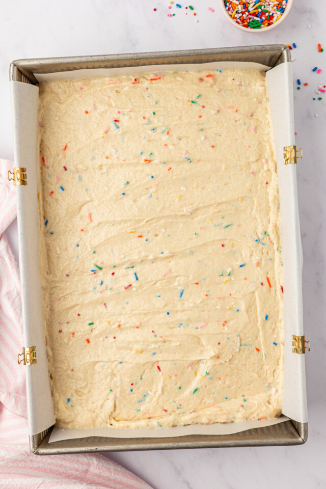 overhead view of funfetti cake batter in a 9x13 baking pan