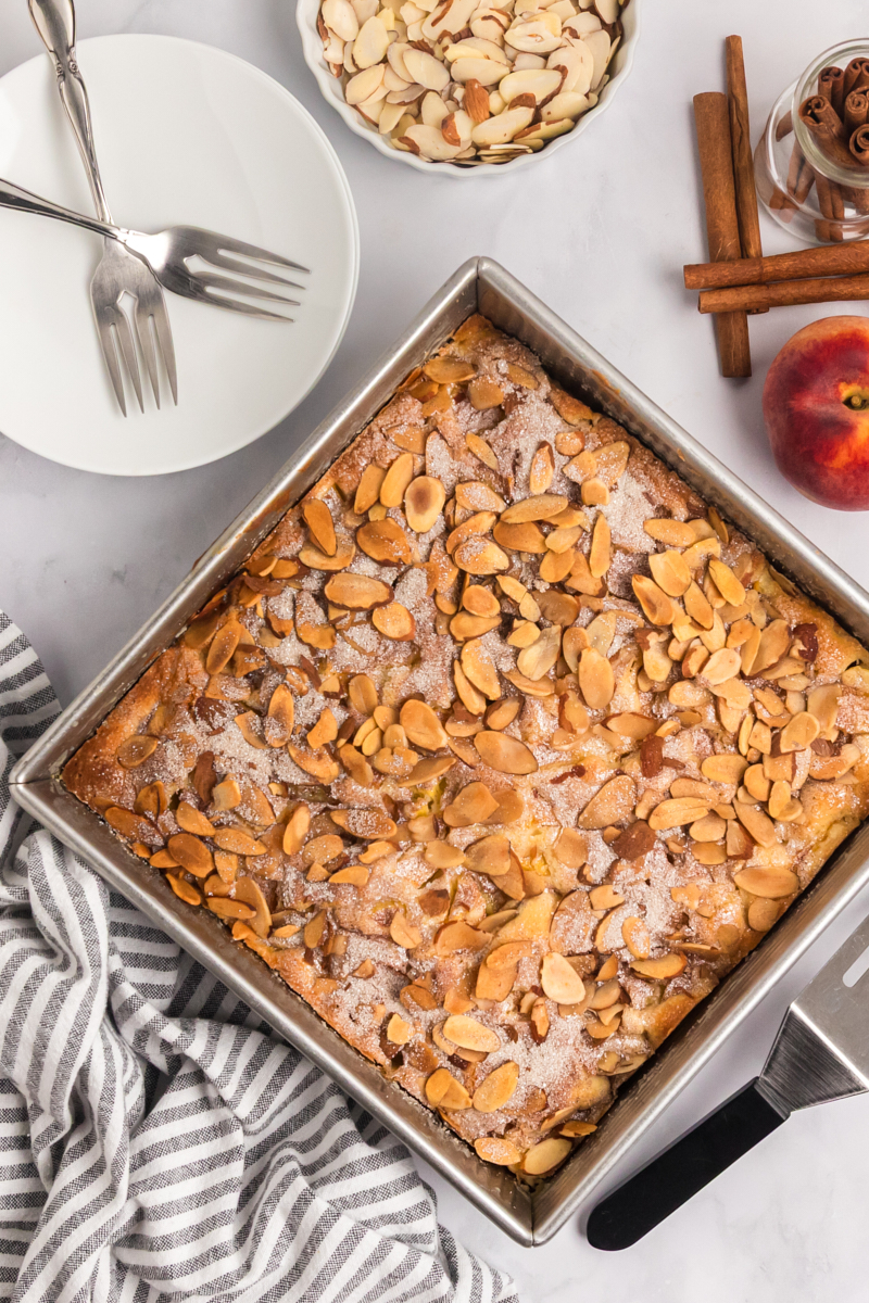 overhead view of freshly baked peach buckle in a square baking pan