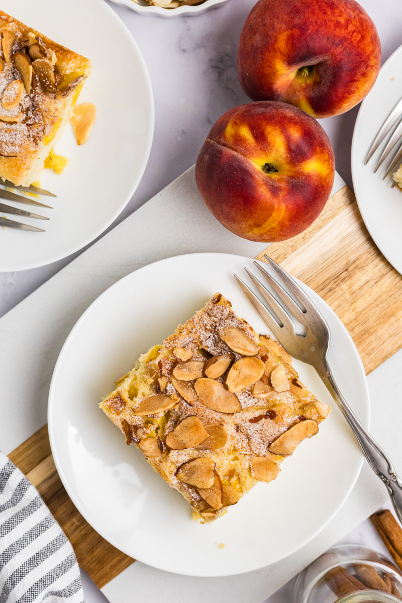 overhead view of a slice of peach buckle with cinnamon-almond topping