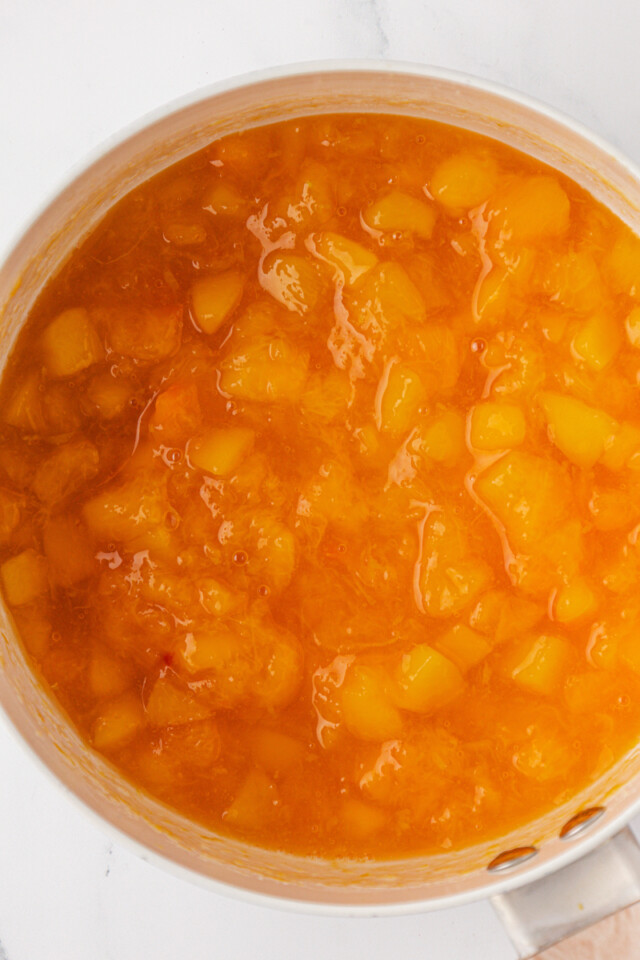 overhead view of peach compote in a saucepan