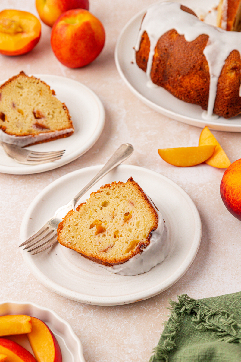 slices of fresh peach cake topped with almond glaze