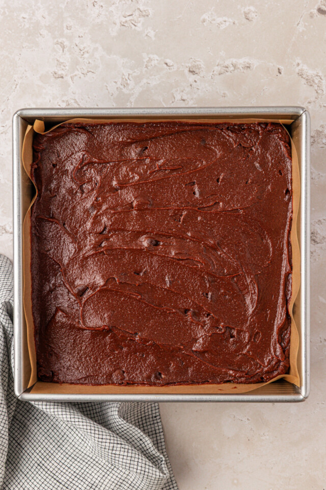sour cream brownie batter spread in a baking pan