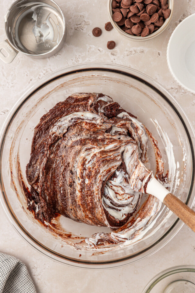 sour cream partially mixed into brownie batter