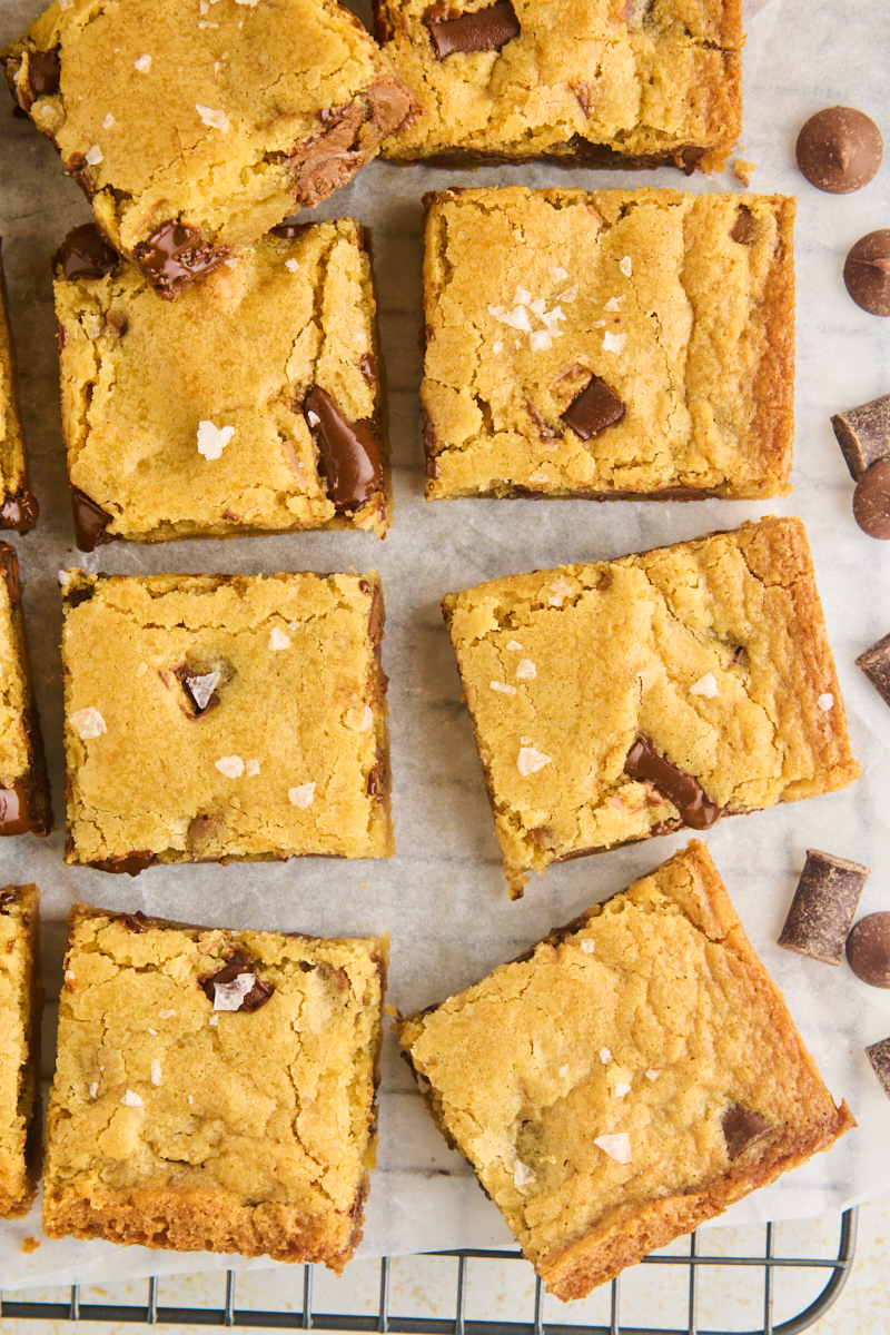 overhead view of sliced chocolate chunk blondies on a wire rack