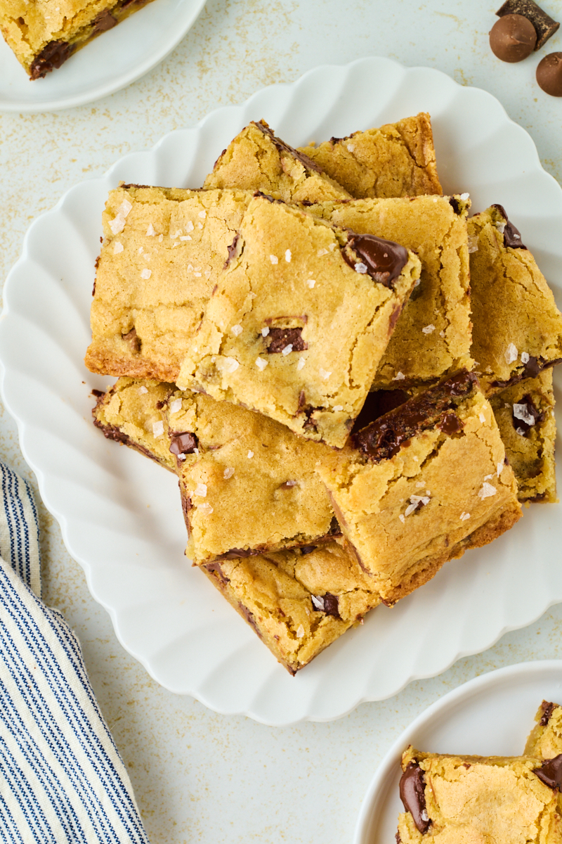 overhead view of chocolate chunk blondies served on a white plate