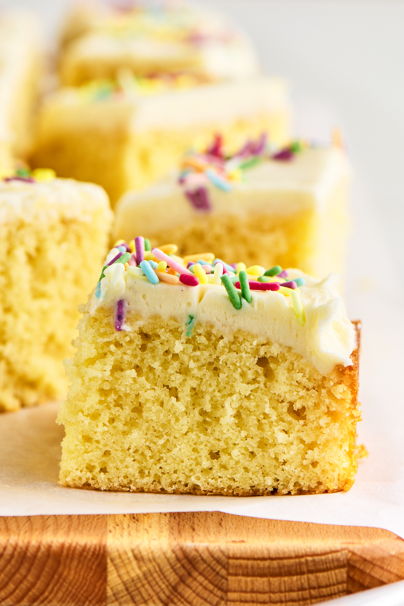 close up of a slice of vanilla sheet cake, showing the soft texture