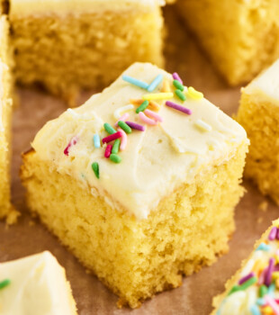 sliced vanilla sheet cake topped with vanilla buttercream frosting