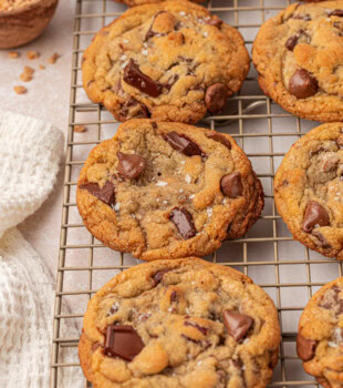 bakery-style loaded chocolate chip cookies on a wire rack