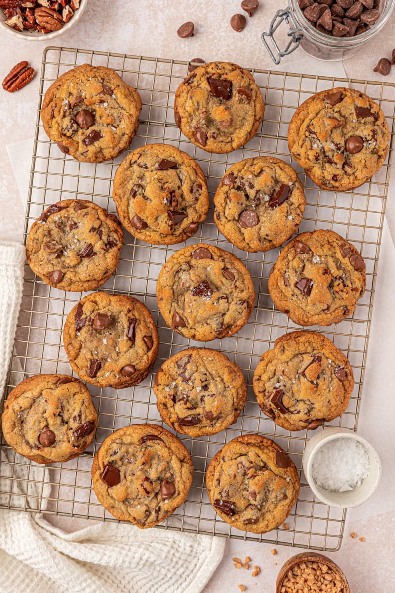 overhead view of bakery-style loaded chocolate chip cookies cooling on a wire rack