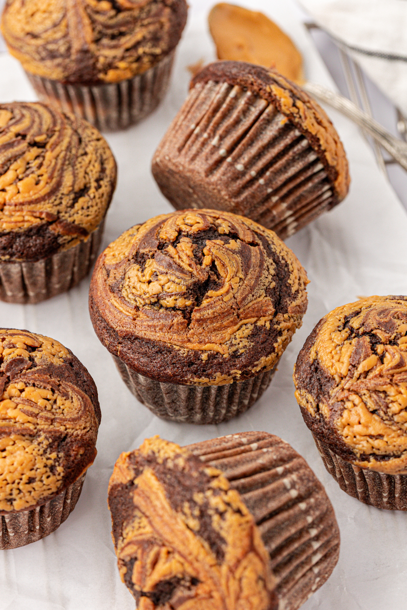several chocolate peanut butter muffins featuring a swirl of peanut butter in a rich chocolate muffin