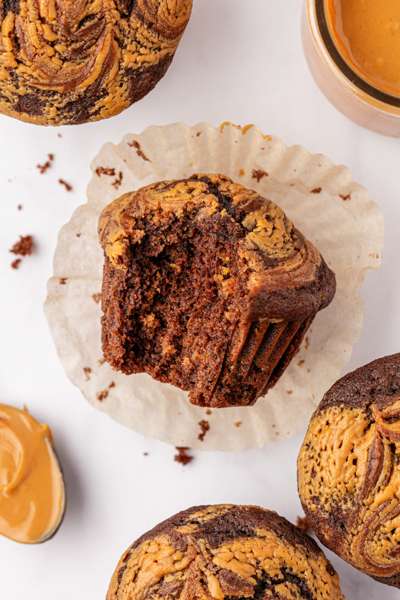 overhead view of a chocolate peanut butter swirl muffin with a bite missing