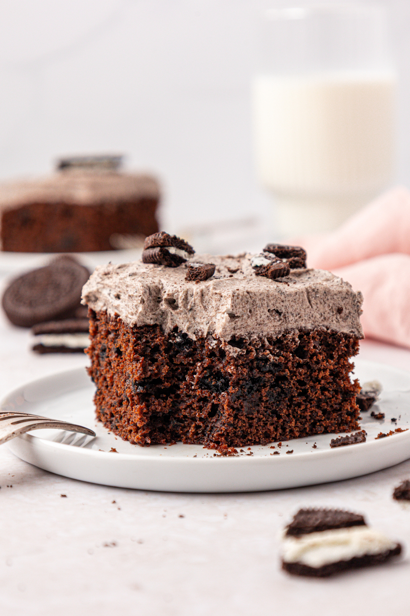 a slice of chocolate Oreo sheet cake with a bite missing