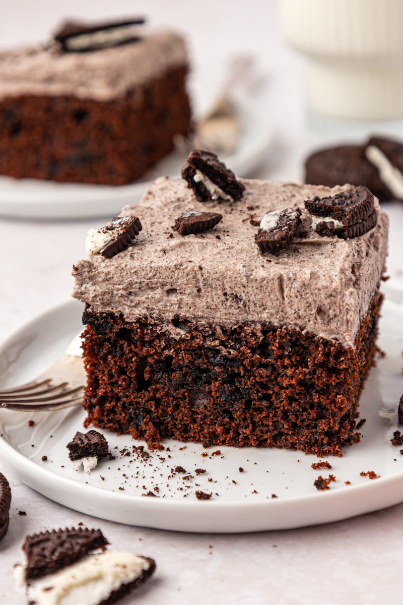 close up of a slice of chocolate Oreo cake with cookies and cream buttercream frosting