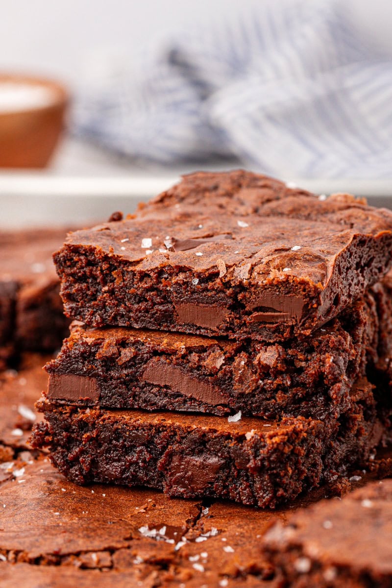 stacked chocolate brownies with fudgy centers, chewy edges, and crackly tops