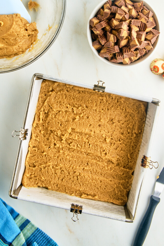 peanut butter blondie batter spread in a square baking pan