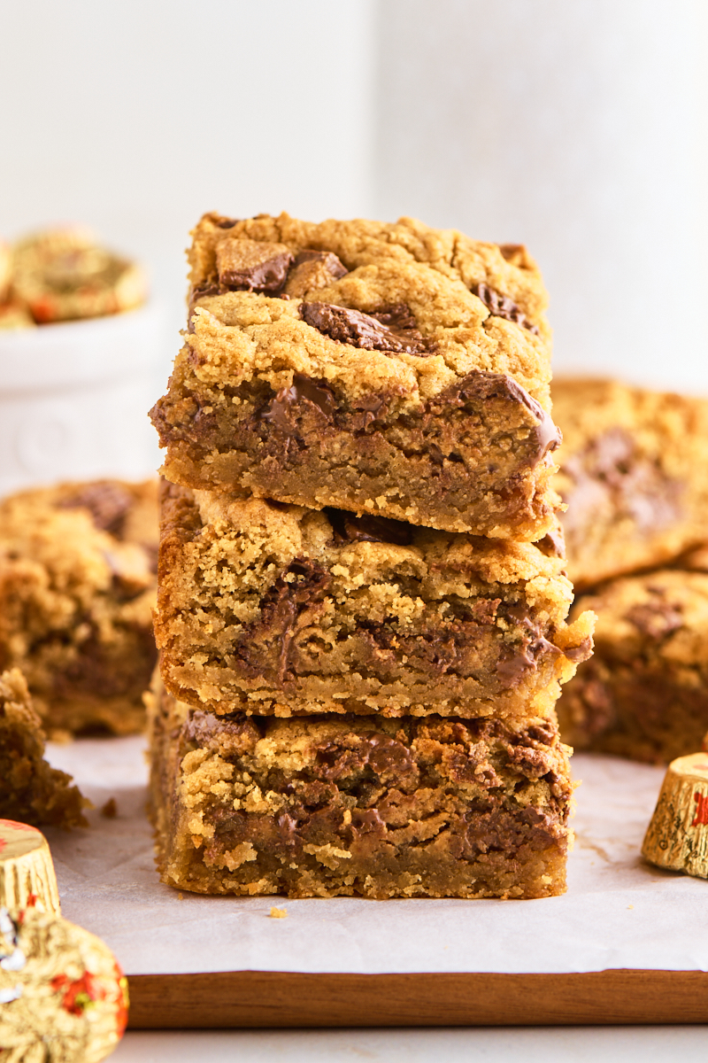 stack of three peanut butter blondies filled with chopped peanut butter cups