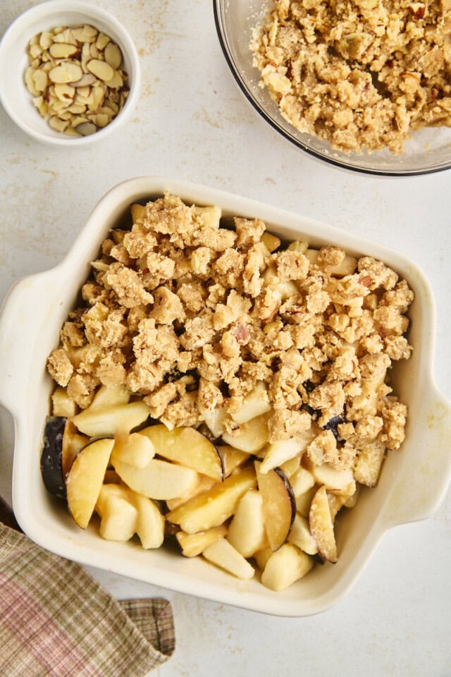 pear and plum mixture partially topped with cinnamon-almond crumble