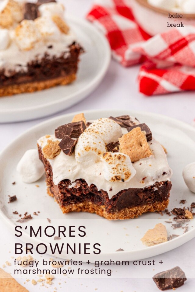 a fudgy brownie with a graham cracker crust and marshmallow frosting; text overlay "s'mores brownies - fudgy brownies + graham crust + marshmallow frosting"