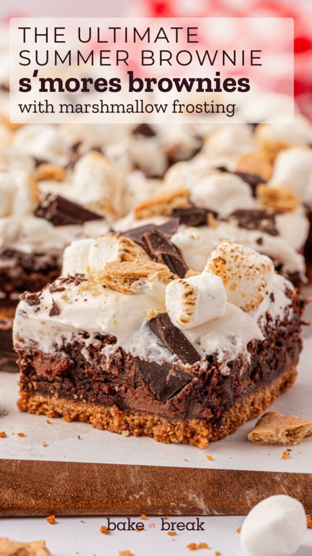 fudgy brownies with a graham cracker crust and marshmallow frosting, topped with toasted marshmallows, chocolate, and cookie pieces; text overlay "the ultimate summer brownie - s'mores brownies with marshmallow frosting"