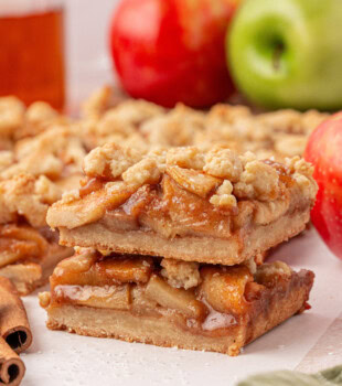 stack of two apple pie bars with thick, buttery crust and crumb topping